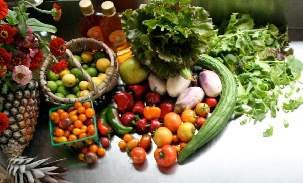 A pile of colorful fresh organic fruits and vegetables show a sample of what's for sale at ARTfarm.