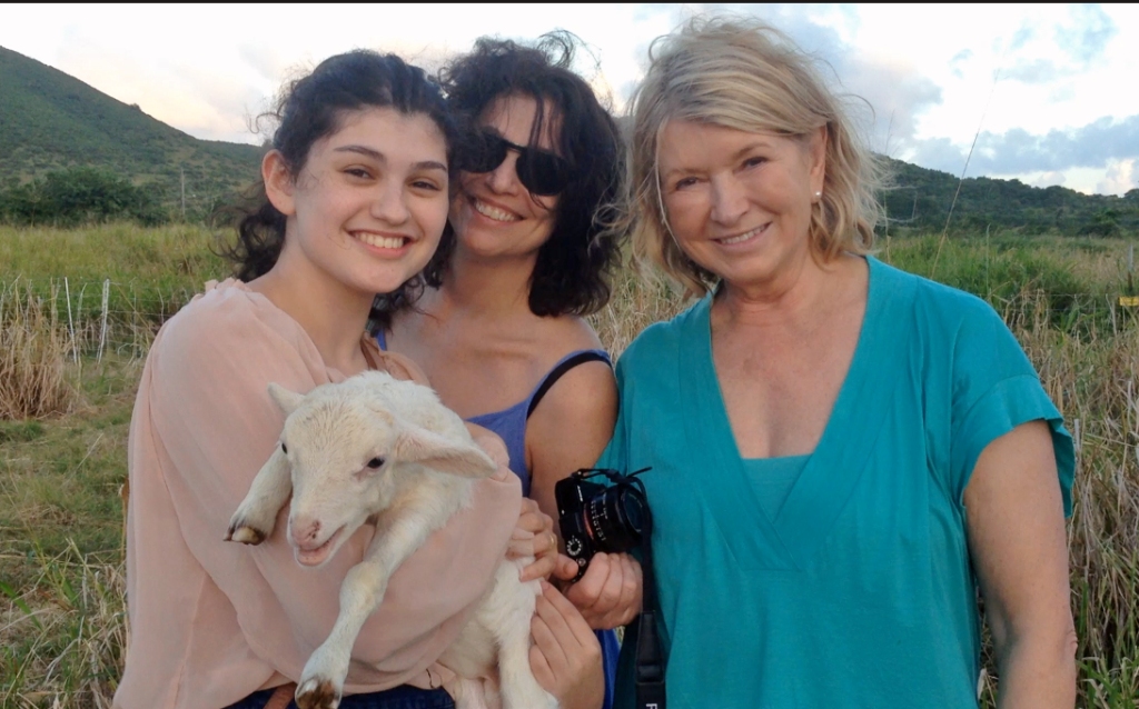 Martha Stewart and some family friends pose with a small white lamb.