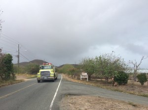 Arriving just behind this 3,000 gallon pumper truck: well-timed backup from Mother Nature. The dark clouds approaching from the east brought a brief but heavy rainshower that helped to extinguish the blazing pastures.